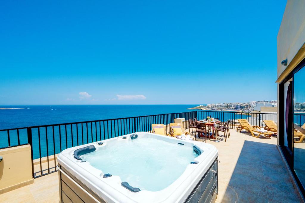 Photo #1 of Islet Promenade Seafront Penthouse with breathtaking seaviews and private hot tub on the large terrace by Getawaysmalta in San Pawl il Baħar, Malta
